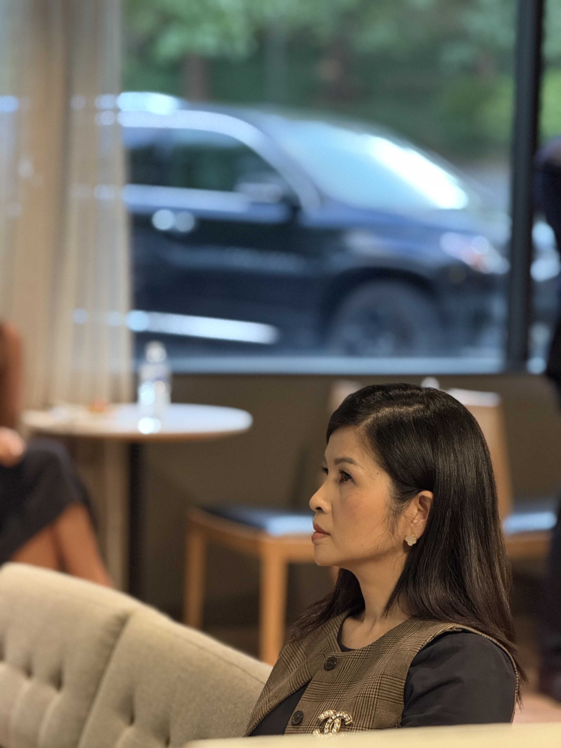 A professional woman, possibly a key partner from DSM Sophia, sits attentively during a meeting related to the property management partnership.