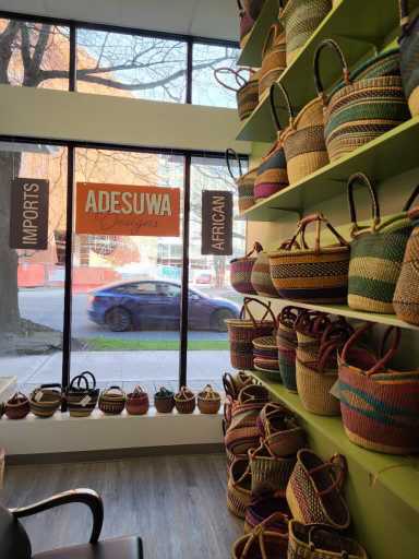 The interior of a **THM Office** retail suite, featuring shelves stocked with imported African woven baskets and bags.