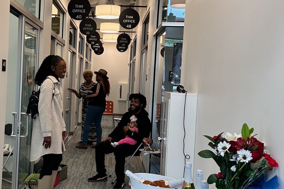 A gathering in the main hallway of **THM Offices**, with people networking, illustrating the vibrant professional environment managed by DSM Sophia.
