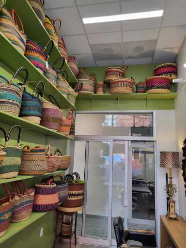 An interior shot of an office suite displaying a wide variety of colorful woven baskets and bags, highlighting a tenant's retail space within **THM Offices**.