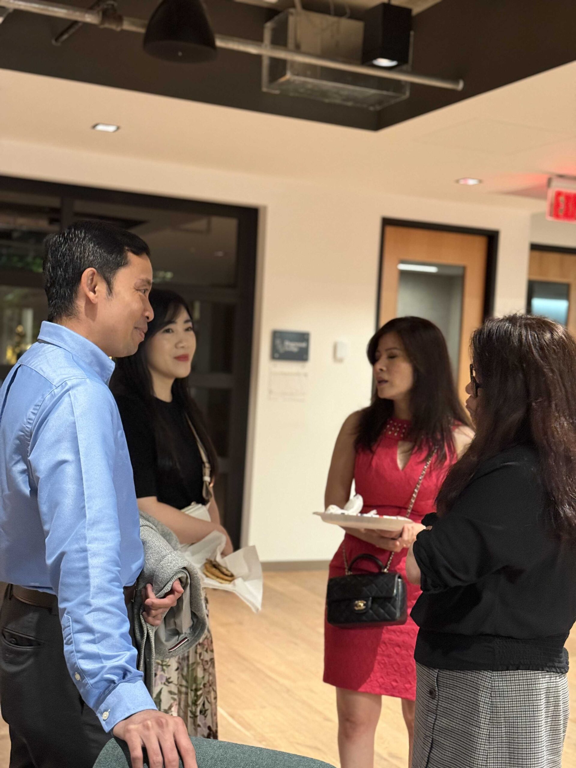 A group of business partners and professionals networking at an event, symbolizing the strong business collaboration between **THM Offices** and DSM Sophia.